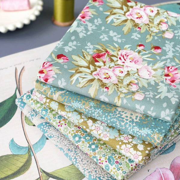 Stack of folded fat quarters in floral quilting fabric